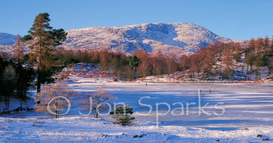 Skaters on Tarn Hows, with Wetherlam behind. Not the model for the tarn in the book, but skating photos are rare!